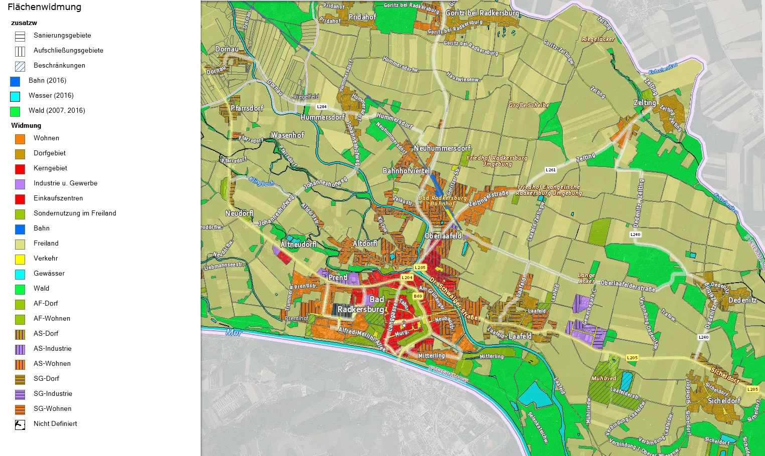 Eine Karte, die Radkersburg mit verschiedenen markierten Bereichen zeigt, einschließlich Wohnviertel, Industriegebieten und Grünflächen. Die Karte enthält wichtige Orte und Straßennamen, sowie einen Fluss und eine Eisenbahnlinie.