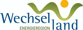 Das Logo für Energie Region, mit einem grünen wellenförmigen Design über dem blauen Text 'energie region'.