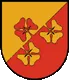 Ein Schild mit rotem und gelbem Hintergrund, der durch eine diagonale Linie geteilt ist. Drei gelbe Blumen mit roten Zentren sind auf dem Schild angeordnet.