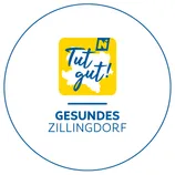 Ein gelber runder Logo mit einer Karte einer Region im Inneren, beschriftet mit 'Tut gut!' und 'GESUNDES ZILLINGDORF' darunter. Die Karte ist in Blau umrandet.