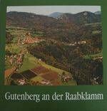 Luftaufnahme einer ländlichen Landschaft mit grünen Feldern, dichten Wäldern und einem Dorf, das im Tal unten eingebettet ist. Das Bild trägt den Titel 'Gutenberg an der Raabklamm'.