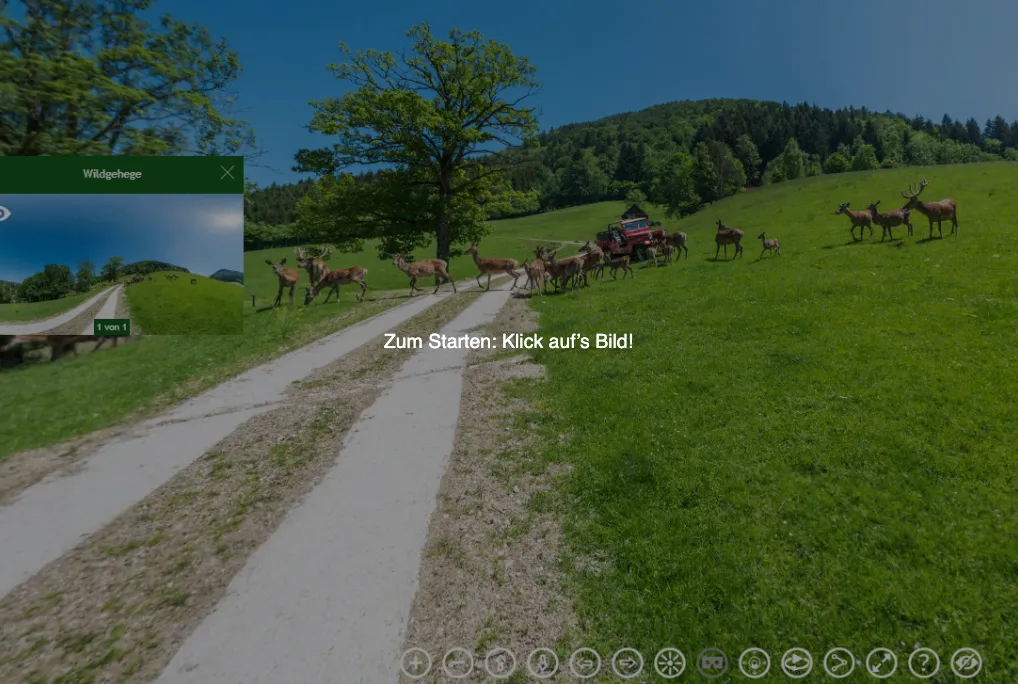 Ein grasbewachsenes Feld mit grasenden Hirschen und einem roten LKW im Blick. Ein Wasserzeichen lautet: 'Zum Starten: Klick aufs Bild!'.