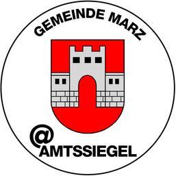 Ein rundes Emblem mit einem Burgdesign, das die Worte 'GEMEINDE MARZ' darüber und '@ AMTSSIEGGEL' darunter zeigt. Die Burg ist in Rot und Weiß dargestellt.