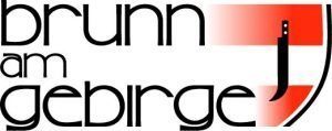 Das Logo für 'Brunn am Gebirge', mit einem Schild, einem stilisierten Buchstaben 'J' und roten und weißen Streifen im Hintergrund.