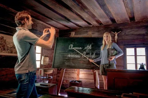 Wood, Clothing, Pants, Person, Furniture, Table, Blackboard, Jeans, Indoors