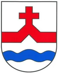 Ein Schild mit einem roten Kreuz auf zwei blauen Wellenlinien auf weißem Hintergrund.