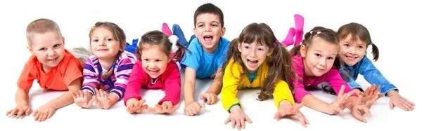Eine Gruppe von Kindern liegt auf einer weißen Oberfläche und lächelt für ein Foto.