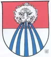 Ein Emblem mit einem stilisierten weißen Gesicht und blauen Streifen, die aus seinem Mund auf einem roten Hintergrund ausgehen.