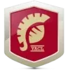Das rote Schild zeigt ein goldenes Emblem eines Löwenkopfes mit einem weißen Umriss. Unter dem Löwen steht das Wort 'VAGL' in Gold. Der Hintergrund ist weiß.