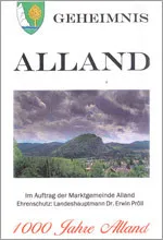 Ein Buchcover mit dem Titel 'Geheimnis Alland' zeigt eine Landschaft mit einem Berg, einem Dorf und einem bewölkten Himmel.