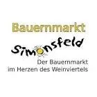 Das Bauermarkt Simonsfeld Logo zeigt eine gelbe Sonne mit Strahlen und den Text 'Der Bauermarkt im Herzen des Weinviertels' in einer stilisierten Schrift.