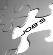 Ein Nahaufnahme eines Puzzleteils mit dem Wort 'JOB'S' darauf geschrieben.
