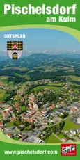 Ein Luftbild einer Stadt mit einem Wappen, umgeben von grünen Feldern, Bäumen und Bergen in der Ferne.