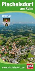 Ein Luftbild einer Stadt mit einem Wappen, umgeben von grünen Feldern, Bäumen und Bergen in der Ferne.